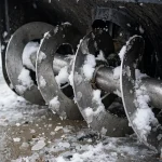 Snowblower auger housing with snow